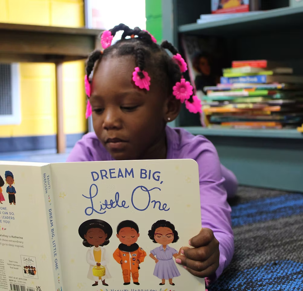 A young scholar participating in S.L.A.M. literacy learning