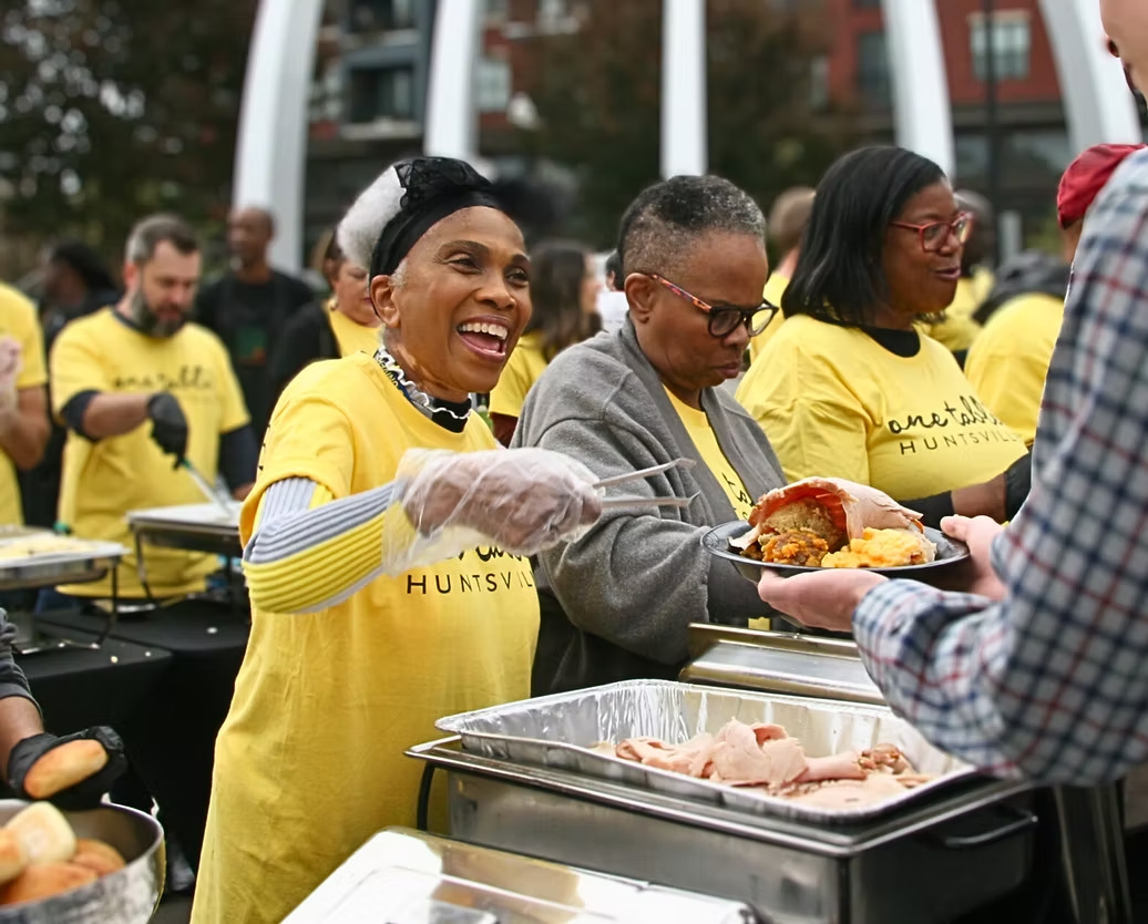 Community members sharing a meal at One Table Huntsville