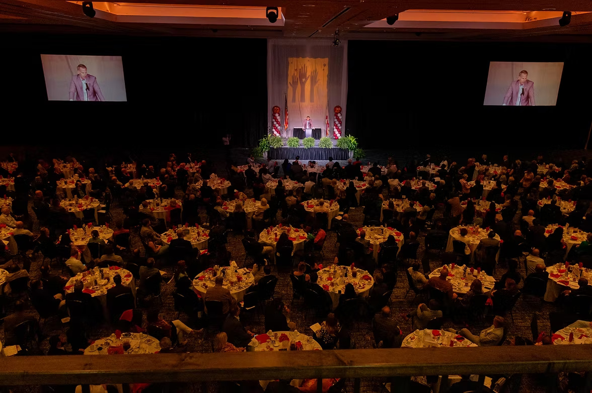 Guests gathered in the ballroom at a Village of Promise Speaker Series event