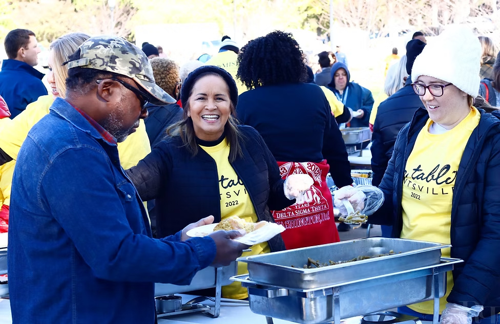 Volunteers serving guests at One Table
